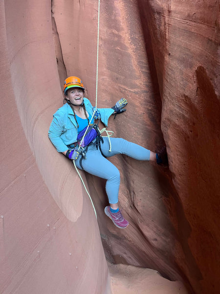 Kate smiles while rock climbing