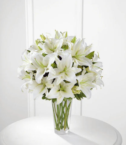 only white casa blanca lilies in a clear glass vase