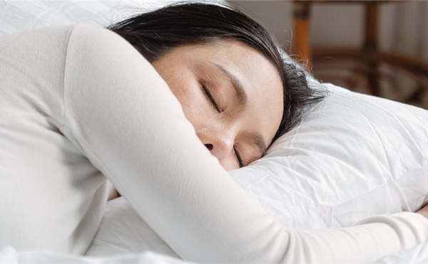 a woman sleeping soundly, on a fluffy pillow