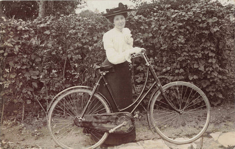 Old postcard of lady with bicycle