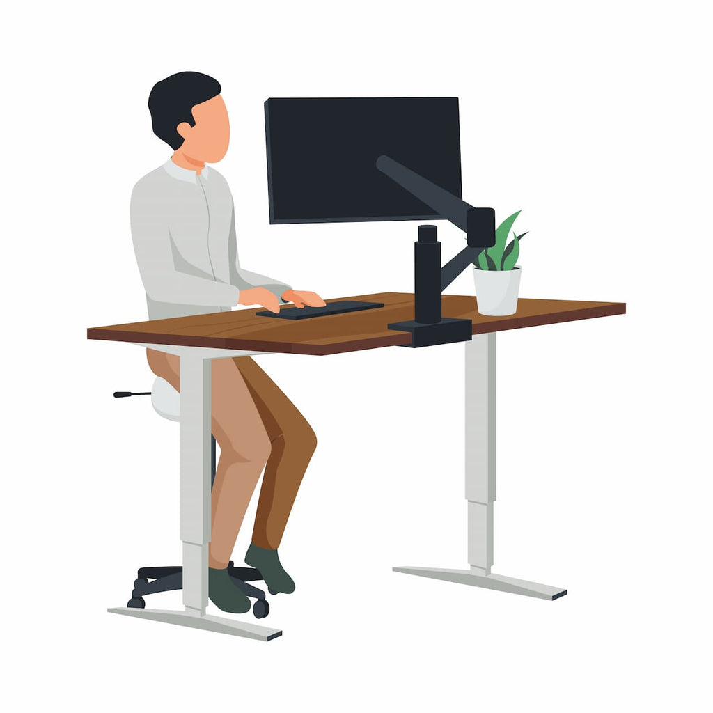 Person using height adjustable table and PRISM+ monitor arm for optimal viewing experience