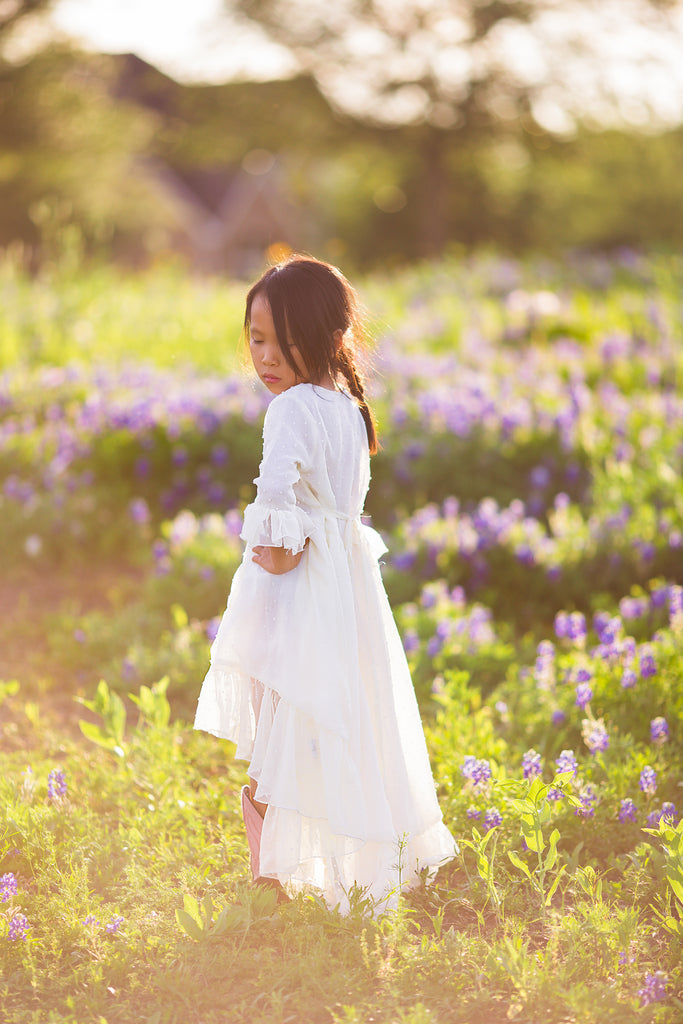 bohemian photoshoot in Texas bluebonnets boho high low ivory dresses for girls