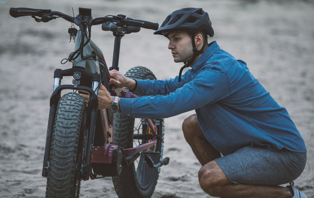 A man doing e-bike maintenance and preventive measures