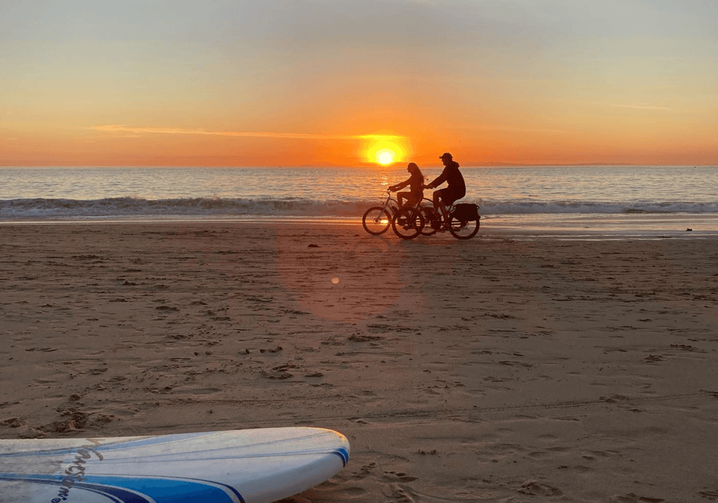 friends at beach riding electric bikes by swell ebike brand
