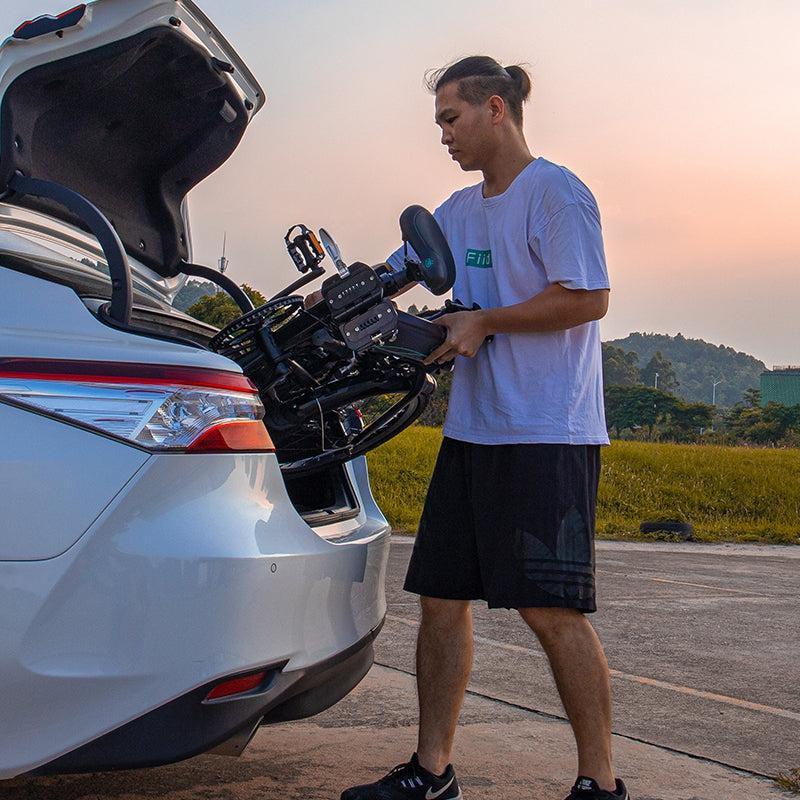 Man putting his folding e-bike in the car/RV