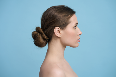 side view of beautiful woman with bun