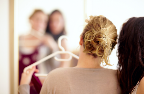 backview of woman holding a clothes on a hanger