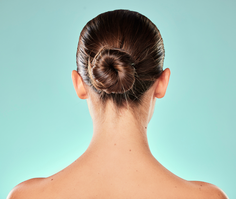 backview of woman's hair in tight bun
