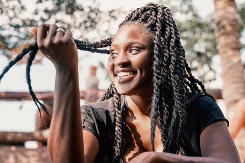 happy woman touching box braids