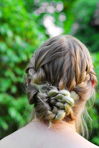 close of woman's hair in a braided bun
