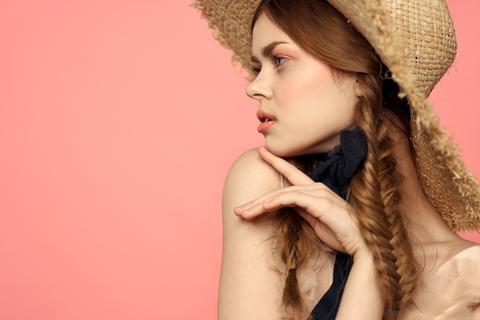 beautiful woman with hat in a french braid