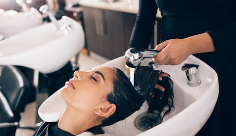 Lady getting hair washed at hairdresser