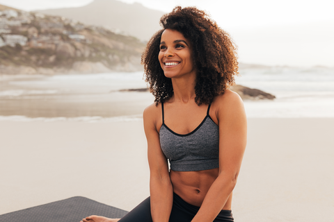 happy woman working out at the beach