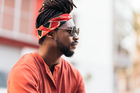 handsome black man with long hair and bandana tied
