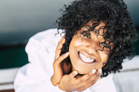 happy black woman smiling at camera