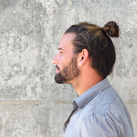 side profile of happy man with man bun