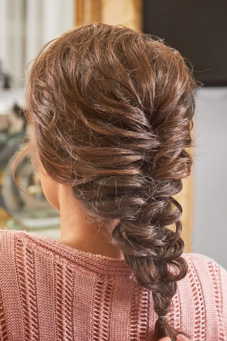 backview of woman's head with a french braid