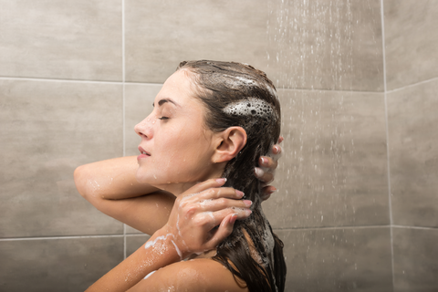 woman with wet shampooed hair in bathroom