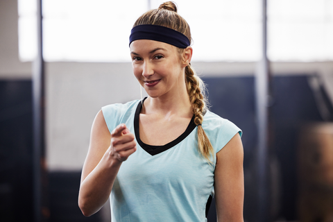 active woman with sweatband and hair in braid