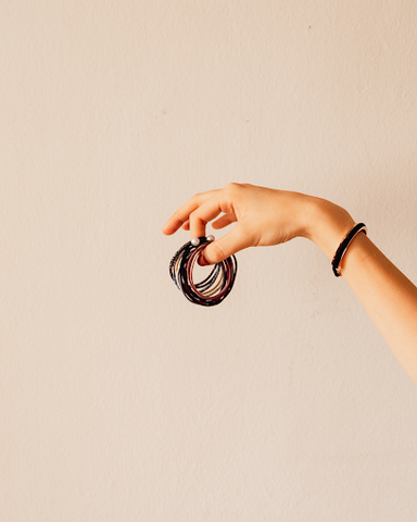 hand holding up hair ties