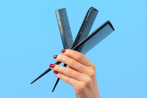 hand holding hair combs