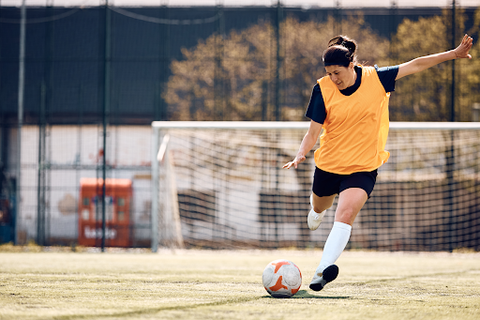 woman playing outdoor soccer