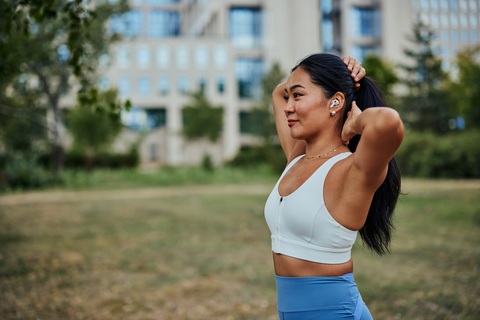 woman in fitness clothes tying up hair