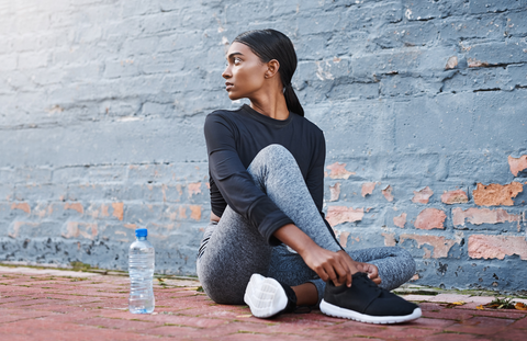 active woman with low ponytail looking behind