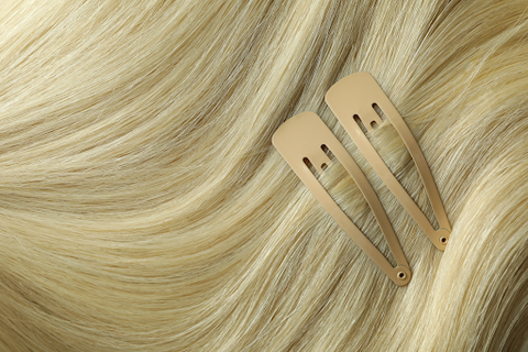 A lady with blonde hair wearing cream colored snap clips in her hair