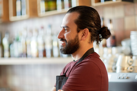 bartender man with man bun smiling