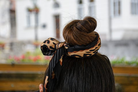 zoom in woman's patterned hair tie tied on a bun