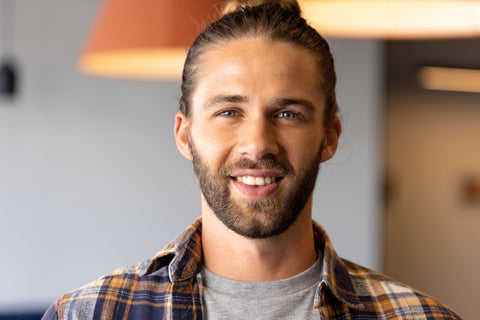 happy man with man bun smiling