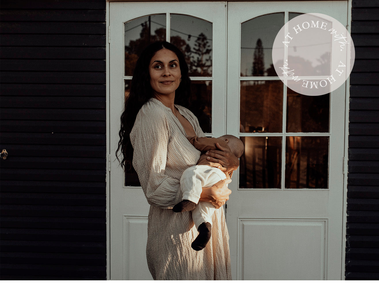 Young women holding her baby and breastfeeding