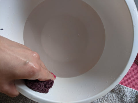 squeezing excess water out of swatch