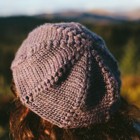 a purple hat is seen from behind showing crown