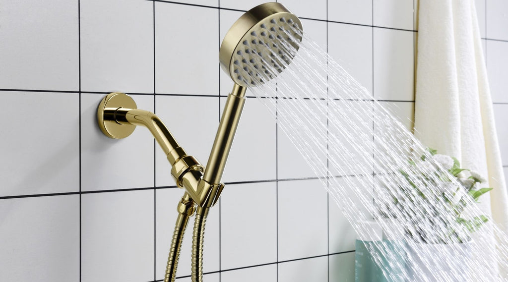 a gold shower head is installed on a white tile shower
