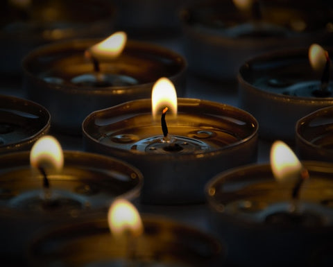 Small wax candles illuminating a dark room