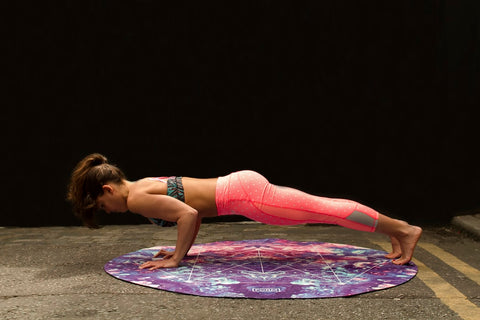 woman doing a push up on a circular mat