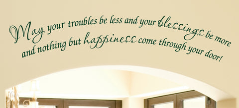A photo showcasing a living room decorated with various Irish wall decals. One decal features the Irish proverb "May your troubles be less and your blessings be more" written in a green script font above a curved archway