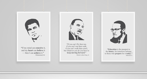 An image of three hanging Black History Month poster prints of faces and quotes by Muhammad Alie, Martin Luther King, Jr and Malcolm X