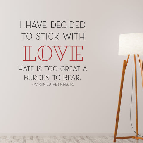 A large wall decal display shown on a wall with a lamp illuminating the words of Dr. Martin Luther King, Jr. that read: I have decided to stick with LOVE, hate is too great a burden to bear.