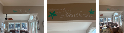 This beach house wall showcases the power of personalized decor with a custom decal proclaiming "Memories made at the beach last a lifetime." Starfish and other coastal accents complement the serene ocean view.