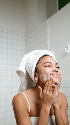 Photo of a woman cleansing her face 