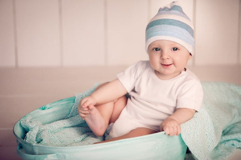 A baby smiling in bodysuit