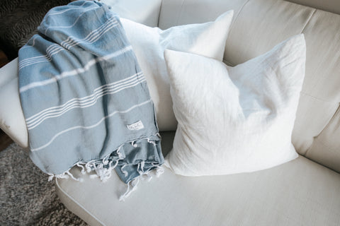 turkish throw towel with tassels on a sofa with pillows