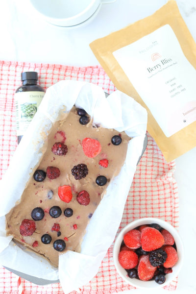 Dairy Free Berry Ice Cream in loaf pan with bowl of berries, philosophie berry bliss and olive nation cherry extract