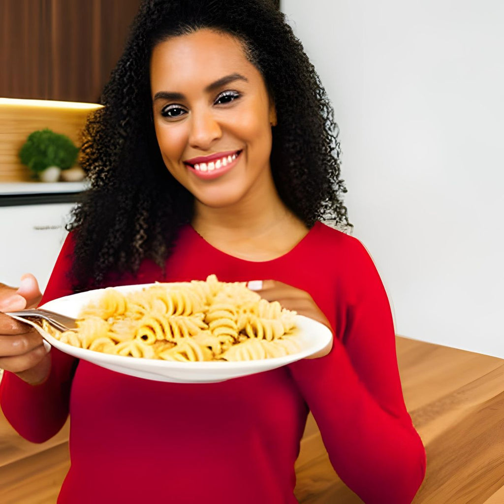 female eating kaizen rotini pasta