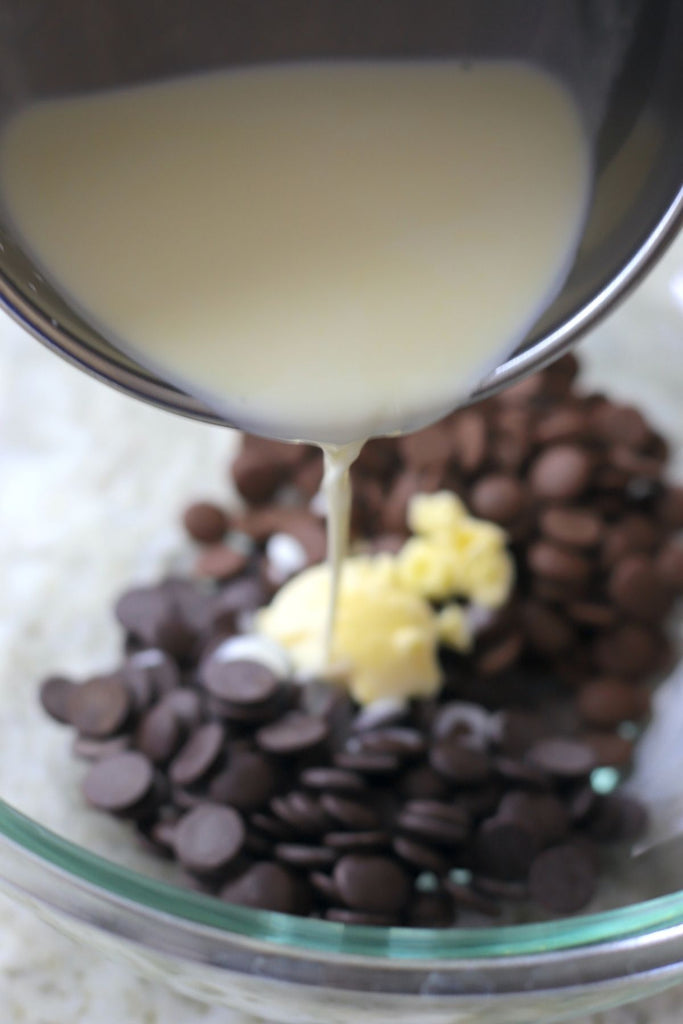 pouring the heavy cream over the chocolate and butter