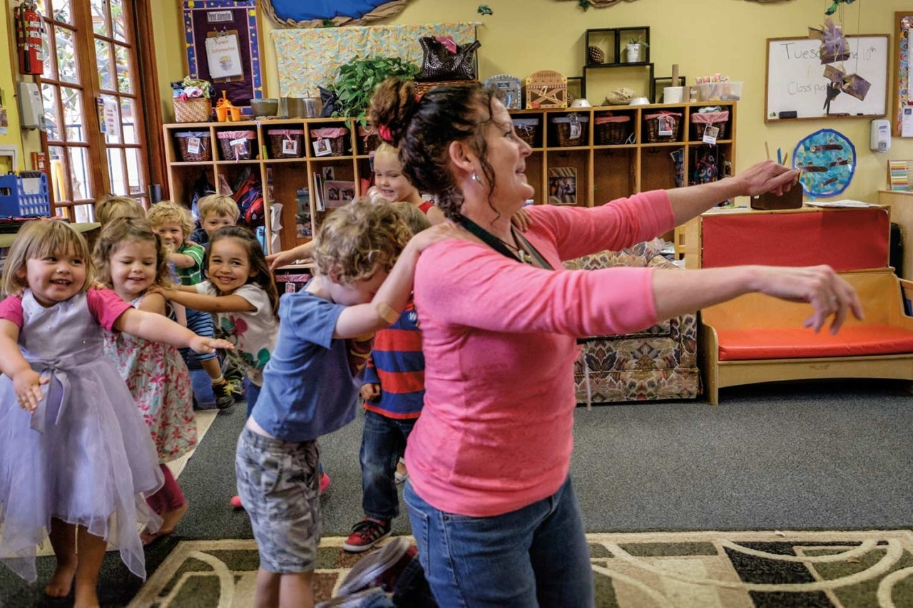 A conga-line of kids behind the pre-school teacher at Patagonia Day Care.