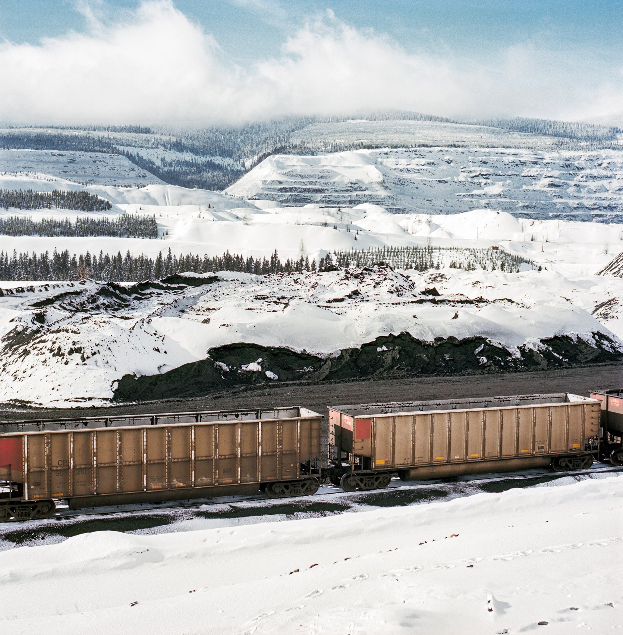 Train cars to be filled with coal at Fording River Operations near Elkford, British Columbia. A significant amount of the coal from Elk Valley travels over 600 miles by rail to Vancouver and then is shipped across the world, primarily to China, where it’s turned into steel. Photo: Kari Medig.